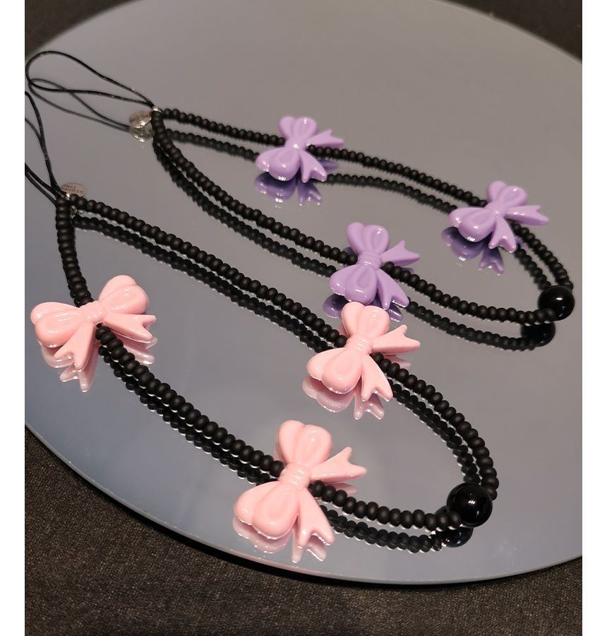 Sangle de téléphone en perles avec nœud