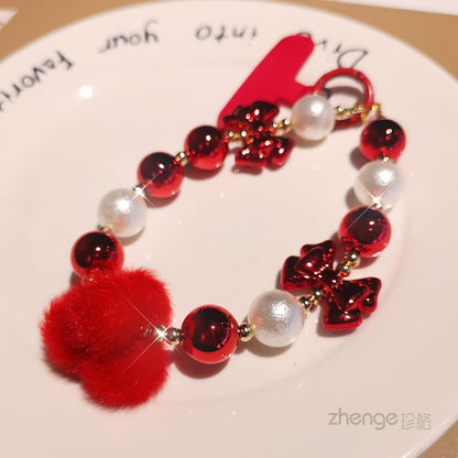 Dragonne de téléphone avec pompon et fausses perles et coussinet pour cordon