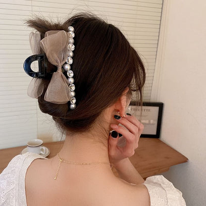 Pince à cheveux avec nœud en fausses perles et strass