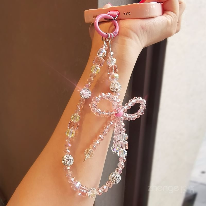 Dragonne de téléphone avec nœud en faux cristal et coussinet pour cordon