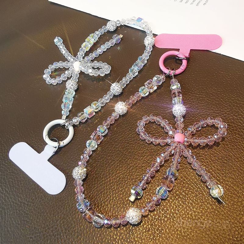 Dragonne de téléphone avec nœud en faux cristal et coussinet pour cordon