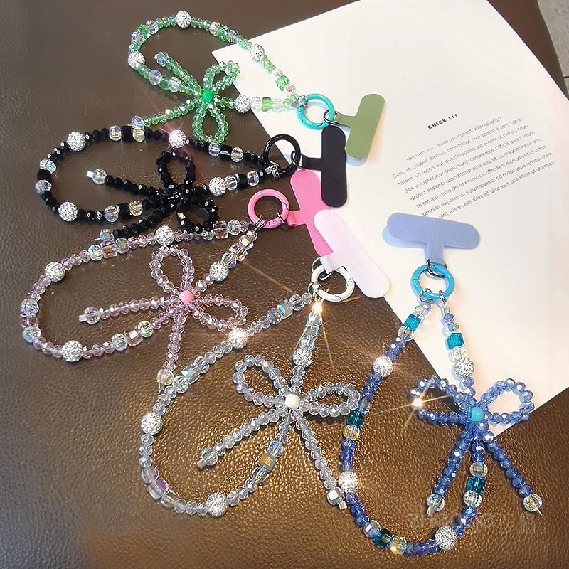 Dragonne de téléphone avec nœud en faux cristal et coussinet pour cordon