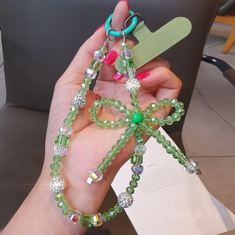 Dragonne de téléphone avec nœud en faux cristal et coussinet pour cordon