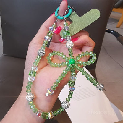 Dragonne de téléphone avec nœud en faux cristal et coussinet pour cordon