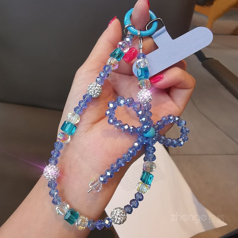 Dragonne de téléphone avec nœud en faux cristal et coussinet pour cordon