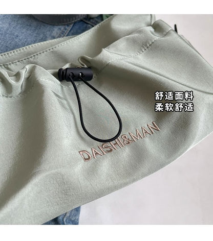 Letter Embroidered Drawstring Crossbody Bag