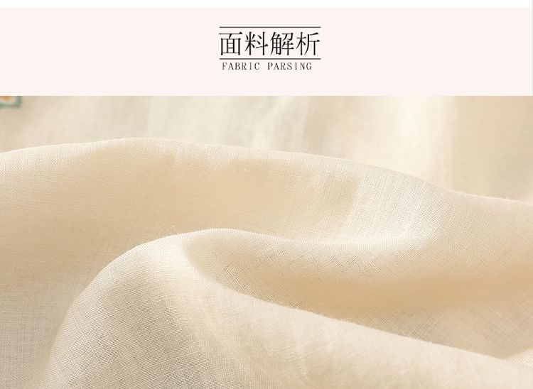 Chemisier brodé de fleurs à manches coudées