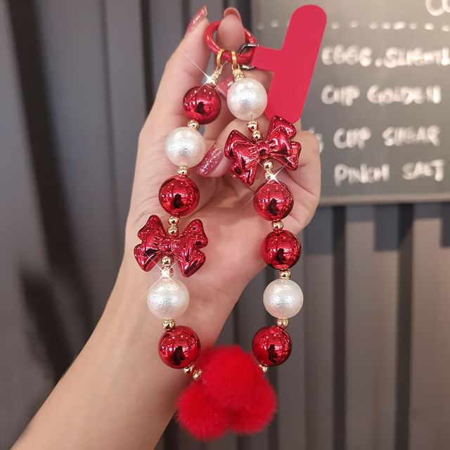 Dragonne de téléphone avec pompon et fausses perles et coussinet pour cordon