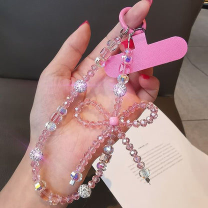 Dragonne de téléphone avec nœud en faux cristal et coussinet pour cordon