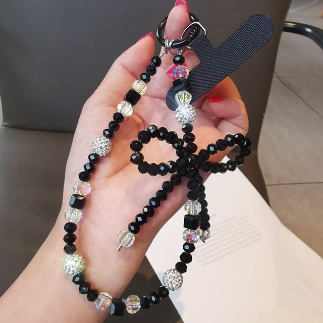 Dragonne de téléphone avec nœud en faux cristal et coussinet pour cordon